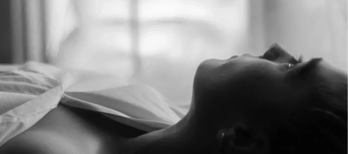 Frau liegt im Bett mit offenen Augen